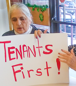 Billie McGregor with poster "Tenants First!"