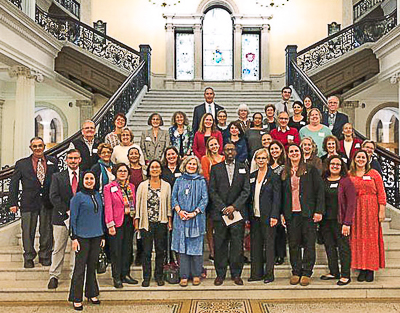 Bending the Arc participants gather on grand staircase at State House