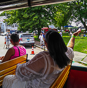 On the trolley in the parade, waving to the crowd
