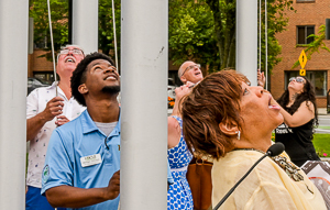 People looking at raised flags