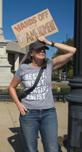 A protestor standing woman holding siggn