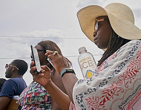 People listening to speeches at the flag raising ceremony