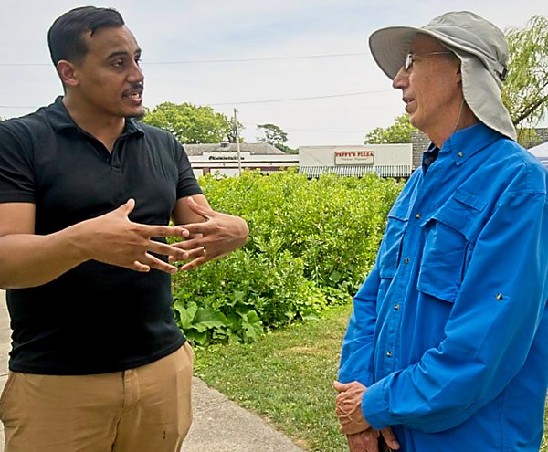 Representative Manny Cruz and Phil Thayer, MCAN board member, talk environmental legislation