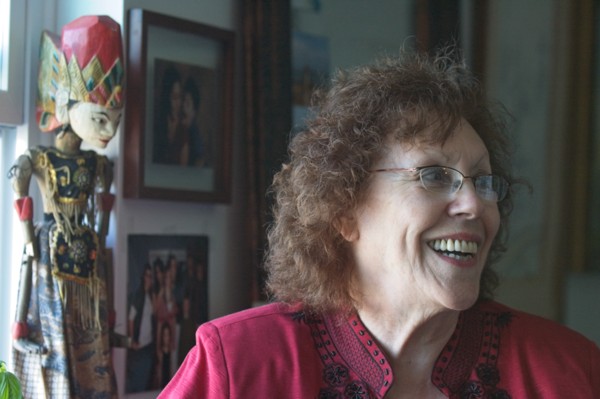 Elderly woman in room with art work