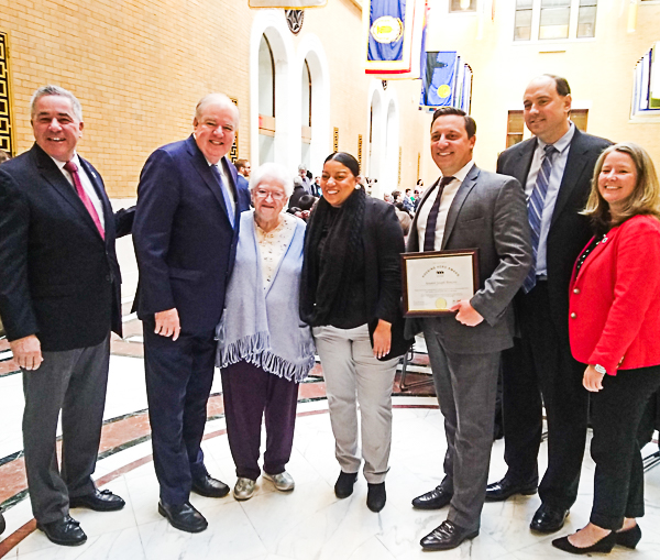 Susan Bonner and legislators in Great Hall, State House