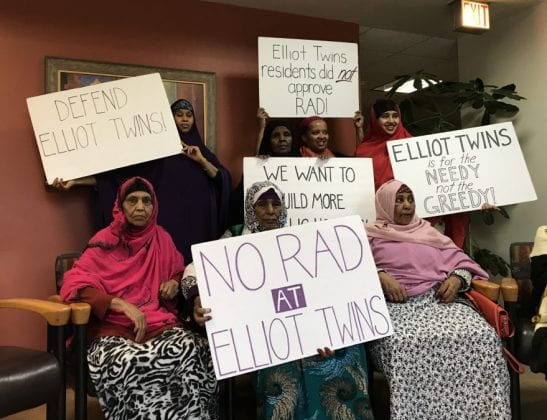 Several people holding signs and demonstrating