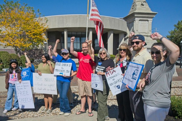 group of people holding signs