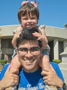 Child on shoulders of man